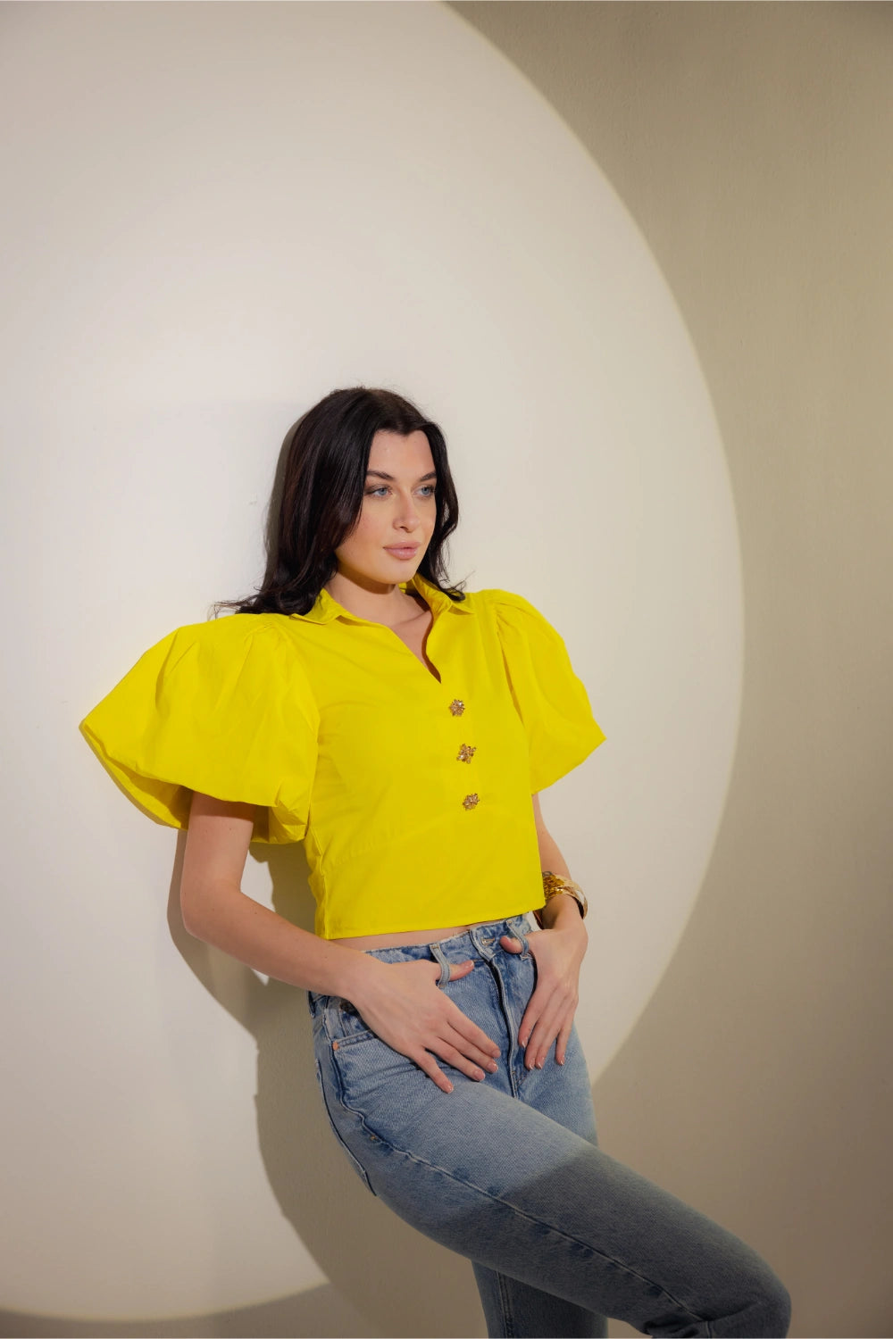 Back view of cropped blouse with gold button accents